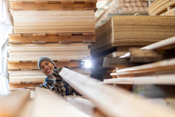 Wall Mural - Young male worker in timber warehouse 