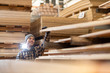 © pikselstock - Young male worker in timber warehouse