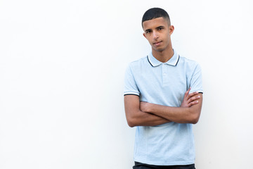 Wall Mural - young arabic man posing by white background with arms crossed