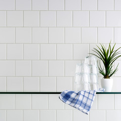 Wall Mural - Glass shelf on tile wall.