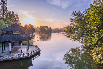 A pavilion during sunrise in West Lake in Hangzhou, Zhejiang province，China with all Chinese words on it only introduces itself which means