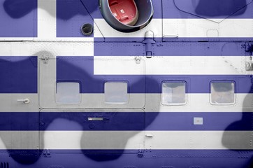 Greece flag depicted on side part of military armored helicopter closeup. Army forces aircraft conceptual background