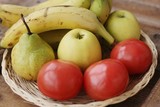 Fototapeta Kuchnia - Fruits and vegetables in a wooden basket on the table