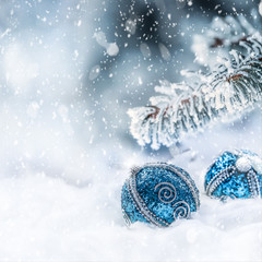 Wall Mural - Blue christmas ball on snow with fir branches. Merry Xmas concept