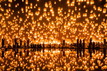 Thai People Release Sky Floating Lanterns Or Lamp To Worship Buddha's Relics With Reflection. Traditional Festival In Chiang Mai, Thailand. Loy Krathong And Yi Peng Lanna Ceremony. Celebration.