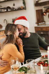 Sticker - Smiling beautiful young couple celebrating Christmas together