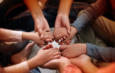 In selective focus of adult and children hands holding together,collaborator,union,joining teamwork concepts,with love and care