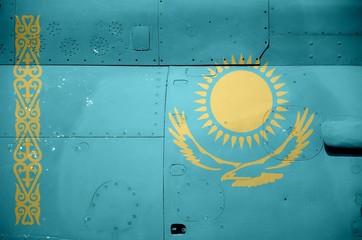 Kazakhstan flag depicted on side part of military armored helicopter closeup. Army forces aircraft conceptual background