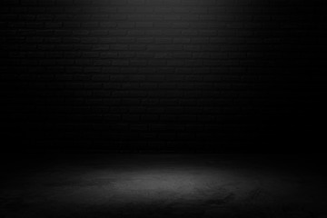 Wall Mural - black brick background with spotlight to concrete ground in studio. dark interior background. room w