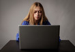 © Marijus - Young woman in blue with laptop.