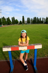 Wall Mural - Little girl have fun on the stadium