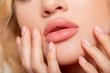 Beautiful lips Close-up. Makeup. Lip matte lipstick. Sexy lips. Part of face, young woman close up. advertisement. Perfect plump lips bodily lipstick. peach color of lipstick on large lips. 