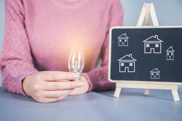 Wall Mural - woman hand bulb with chalkboard