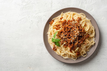 Wall Mural - Spaghetti pasta bolognese in plate on concrete background. Top view, copy space.