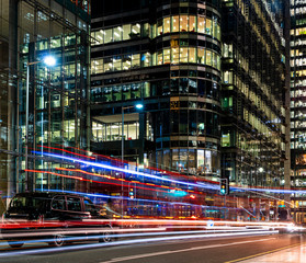 Busy city street at night with light streaks from vehicles