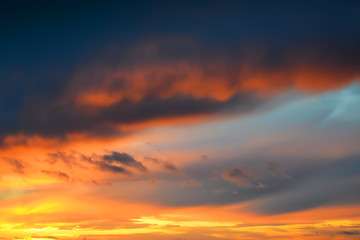 Wall Mural - dark thunderclouds on a golden sky during sunset. afterglow of sunset. scenic sundown cloudscape for