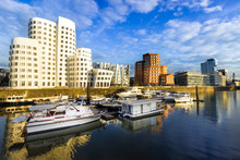 Düsseldorf, Germany - Boats In The Water And Buildings In The City Harbour Medienhafen Port In Dusseldorf Germany