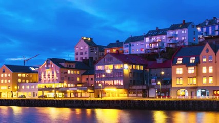 Wall Mural - Kristiansund, Norway. View of city center of Kristiansund, Norway during the cloudy night with colorful sky. Time-lapse of port with historical buildings, panning video