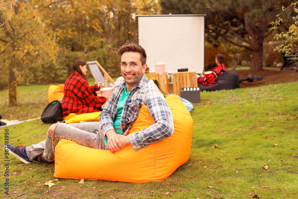 Happy young man in outdoor cinema