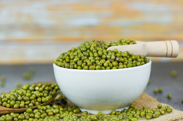 Mung beans on bowl agricultural products on the sack - dry green mung beans