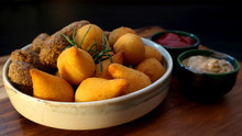 Traditional Brazilian Snacks Coxinha And Quibe On Wooden Dark Background. Selective Focus.