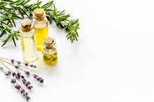 Aromatherapy. Essential Oils In Small Bottles Near Fresh Herbs On White Background Copy Space