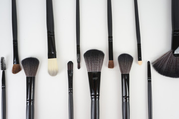 Wall Mural - A set of a black make up brushes over the white background