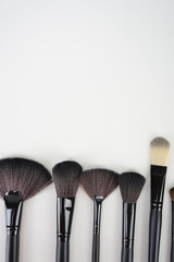 Wall Mural - A set of a black make up brushes over the white background