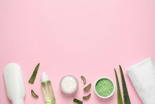Flat Lay Composition With Aloe Vera And Cosmetic Products On Pink Background. Space For Text