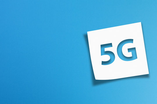 Note paper with 5G communication wifi technology concept on blue background