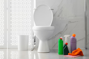 Wall Mural - Toilet bowl and cleaning supplies in modern bathroom