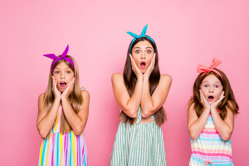 Sticker - Portrait of impressed girls with color headbands screaming omg touching their cheeks hearing news wearing dress skirt isolated over pink background