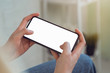 © sompong - Woman hand hold smart phone with blank copy space screen for your advertisement.
