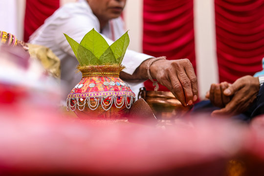 Indian wedding ceremony : decorative coper kalash with green leaf and coconut 