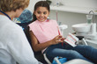 © Yakobchuk Olena - Joyful smiling girl visiting her professional dentist