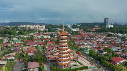 Wall Mural - 4K Aerial footage of Chinese Temple Peak Nam Toong Pagoda located in the city of Kota Kinabalu, Sabah, Malaysia.