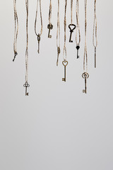 vintage keys hanging on ropes isolated on white