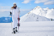 Woman Skier  Wearing White Healmet With Mask In Snow Winter Mountain