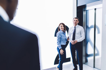 Wall Mural - Multiracial coworkers having conversation in corridor in office