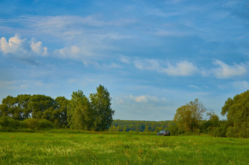 Peaceful rural summer european landscape with green trees and water