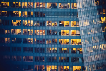 Wall Mural - Aerial view of various high Manhattan skyscrapers buildings with lighted windows located in New York city at evening time. Night life of metropolis, offices and real estate. Downtown structures