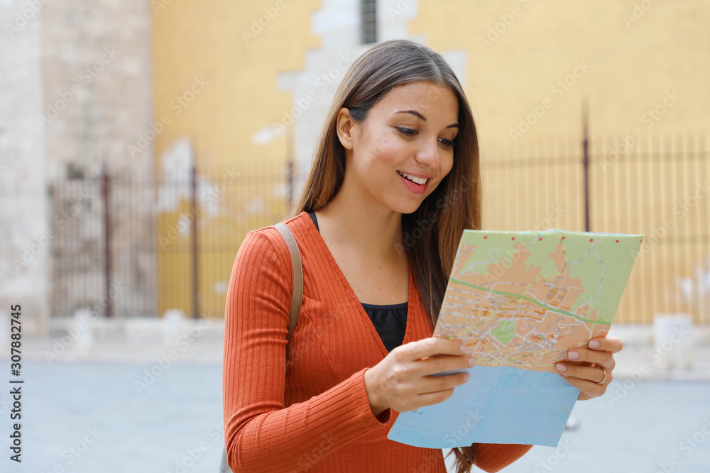 Visiting Direction Travel girl visiting city searching direction on map. Happy cheerful ...