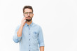 © Mangostar - Pensive focused guy speaking on cellphone, having serious phone talk. Handsome young man in casual shirt and glasses standing isolated over white background. Communication concept
