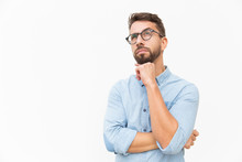 Pensive Customer Thinking Over Special Offer, Touching Chin, Looking Up. Handsome Young Man In Casual Shirt And Glasses Standing Isolated Over White Background. Advertising Concept