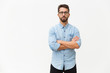 Successful confident male entrepreneur posing with arms folded. Handsome young man in casual shirt and glasses standing isolated over white background. Confident man concept