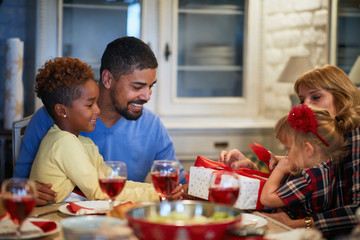 Wall Mural - family opening Christmas presents at table