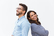 © Mangostar - Joyful couple standing back-to-back and laughing at joke. Young woman in casual and man in glasses in glasses posing isolated over white background. Healthy relationship concept