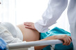 Female doctor examines the check of gestational age. Concepts of health care during pregnancy