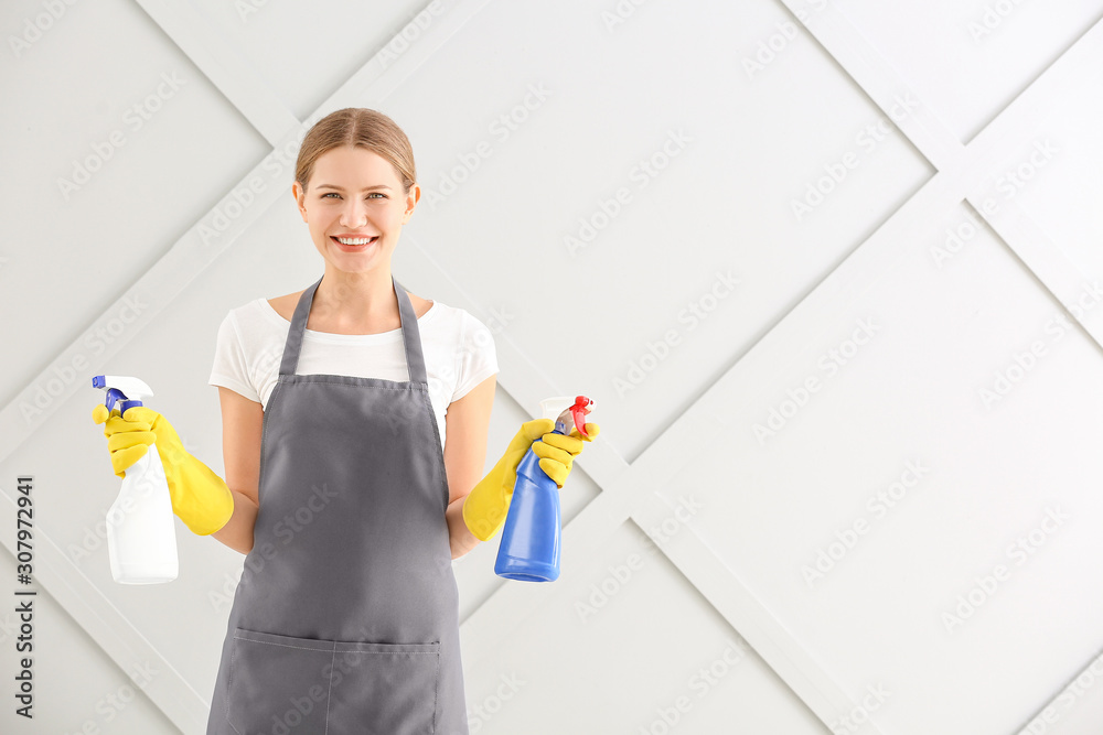 Female janitor on grey background