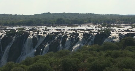 Wall Mural - famous Ruacana waterfalls on the Kunene River, Northern Namibia border, Africa wilderness landscape, Waterfall is full of water after rain season.